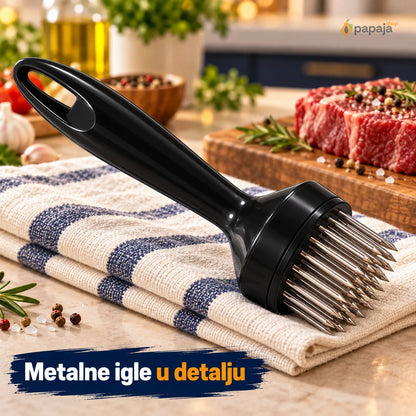 Metalne igle i kružno podnožje omekšivača oslonjenog na kuhinjsku krpu